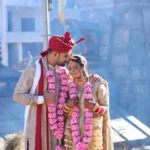 Couple in traditional wedding attire in Triyuginarayan temple wedding.
