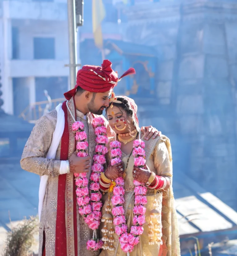 Couple in traditional wedding attire in Triyuginarayan temple wedding.